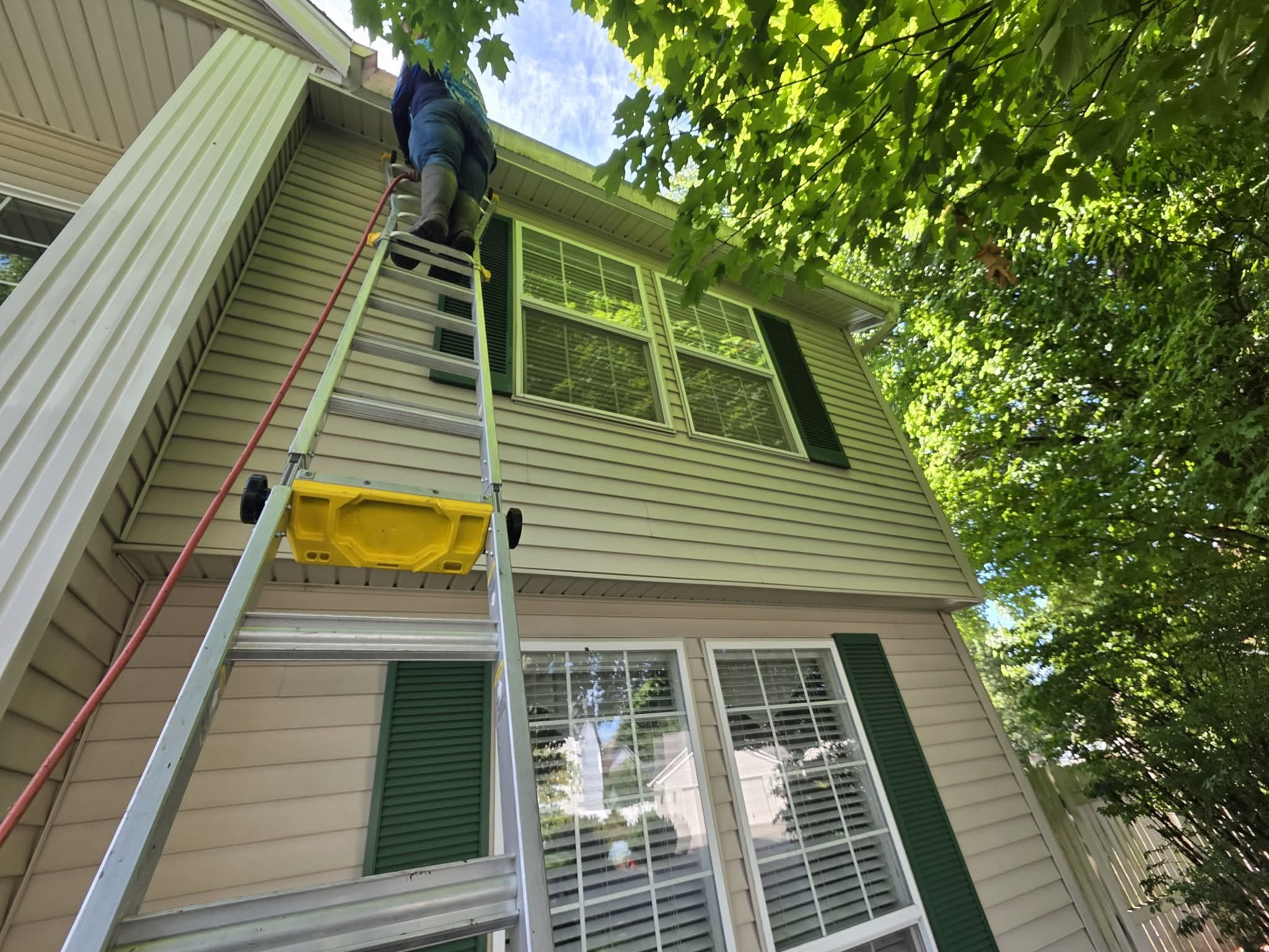 Gutter cleaning on a two-story home