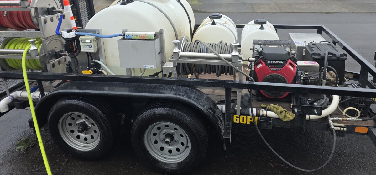 Hose reels, tanks and engine on the Mountain View Pressure Washing And Softwash trailer