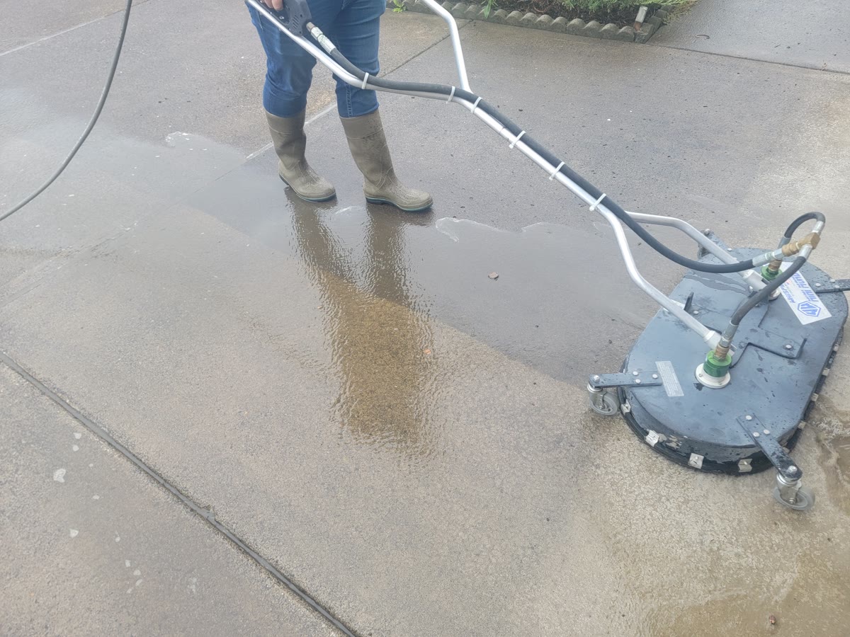 Surface cleaner cleaning a concrete driveway in Clark County, WA